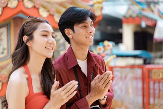 Happy travelers enjoying Chinese New Year festivities at a colorful temple, embracing cultural traditions and vibrant celebrations.