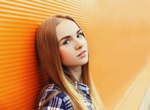 Portrait closeup beautiful young girl over colorful background