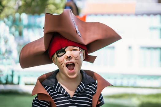 Boy Cat Pirate costume. Halloween party in kindergarten. Aqua makeup painted kids face. Bright festive.