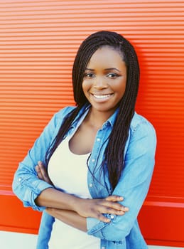 Portrait beautiful smiling african woman over red background