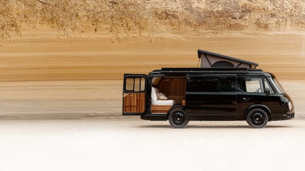 Sleek black camper van is parked in a field, its door open to reveal a cozy interior, inviting you to experience the freedom of the open road