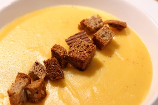 Savor creamy pumpkin soup topped with crispy croutons, adding texture and flavor for your autumn gatherings
