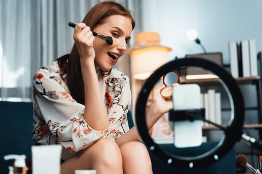 Woman influencer shoot live streaming vlog video review makeup utmost social media or blog. Happy young girl with cosmetics studio lighting for marketing recording session broadcasting online.