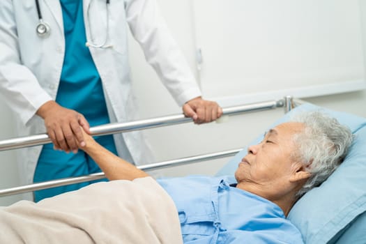 Doctor checking senior patient woman lie down on a bed in the hospital, healthy strong medical concept.