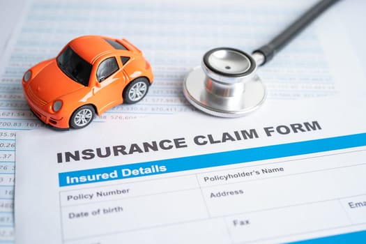 BANGKOK, THAILAND JULY 1, 2022 Stethoscope on Insurance claim accident car form, Car loan, insurance and leasing time concepts.