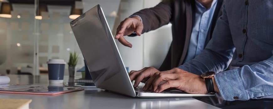 Business People Meeting using laptop computer,calculator,notebook,stock market chart paper for analysis Plans to improve quality next month. Conference Discussion Corporate Concept