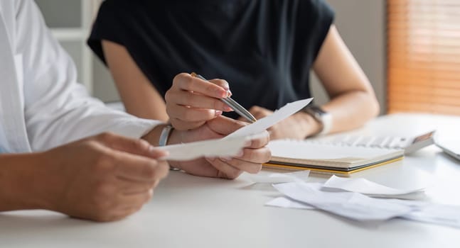 Asian couple analyze expense or finance in deposit account and daily income bill together. savings economy concept.