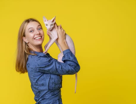 Woman shares heartwarming moment with beloved cat and kisses it affectionately and holds it in hands. Deep bond and love between pet owner and feline companion, reflecting joyful and cherished connection. High quality photo