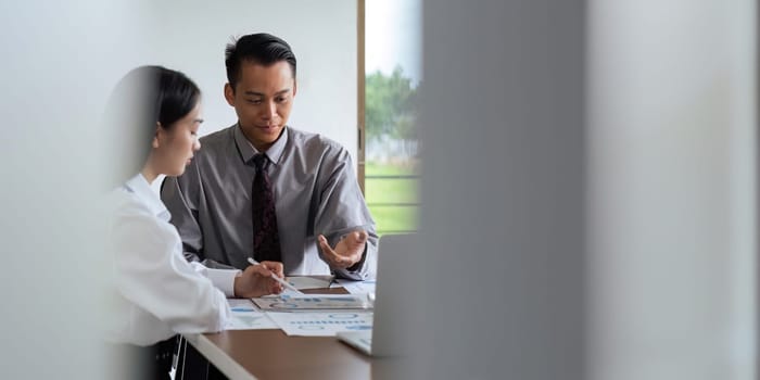 Asian business team meeting to analyze and discuss the situation on the financial report in the meeting room. Investment Consultant, Financial advisor and accounting concept.