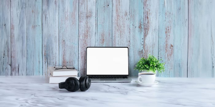 Laptop computer mockup blank white screen on table in wood background. Laptop with blank screen on table of workplace contemporary wood background.