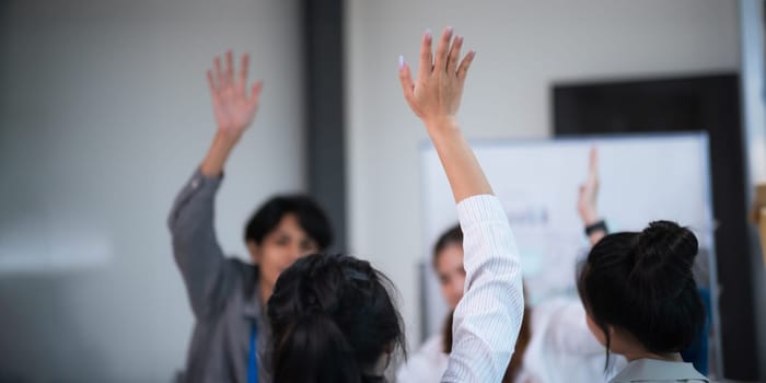 Businesspeople giving a high five to male colleague in meeting teamwork. business professionals high five during a meeting success, togetherness in boardroom.