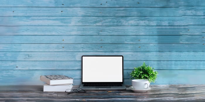 Modern laptop computer, Coffee cup, laptop on wooden table. Studio shot isolated on white. mockup blank screen for graphics display montage contemporary.