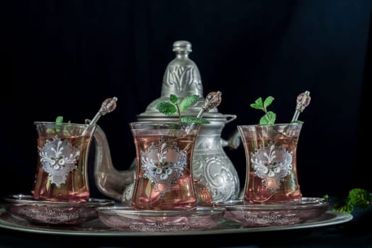 traditional Moorish mint tea service on a tray with decorated glass