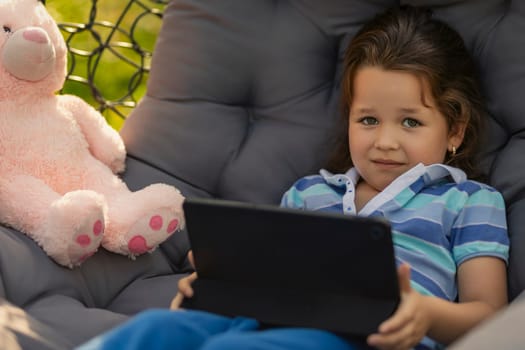 little girl looking at tablet, modern outdoor recreation