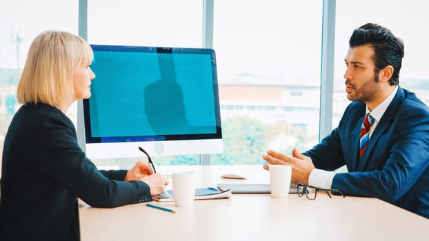 Business people in the conference room with green screen chroma key TV or computer on the office table. Diverse group of businessman and businesswoman in meeting on video conference call . Jivy