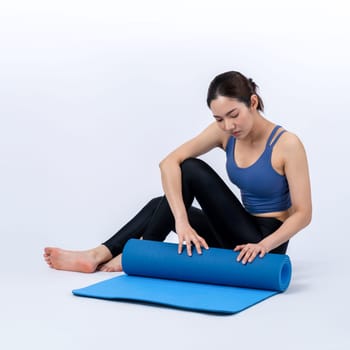 Young attractive asian woman portrait in sportswear with exercising mat. Healthy exercise and workout routine lifestyle concept. Studio shot isolated background. Vigorous