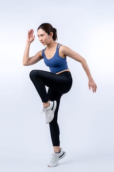 Side view young athletic asian woman on running posture in studio shot on isolated background. Pursuit of healthy fit body physique and cardio workout exercise lifestyle concept. Vigorous