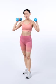 Vigorous energetic woman doing dumbbell weight lifting exercise on isolated background. Young athletic asian woman strength and endurance training session as body workout routine.