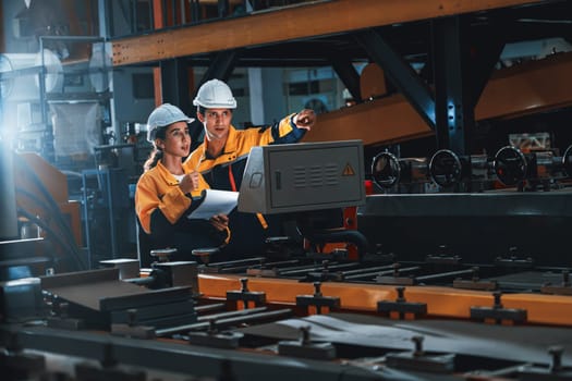 Professional quality control inspector conduct safety inspection on steel machinery and manufacturing process. Factory engineer or operator make optimization in heavy industry facility. Exemplifying