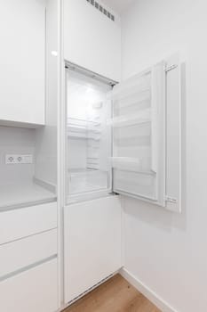 A white refrigerator freezer inside of a kitchen