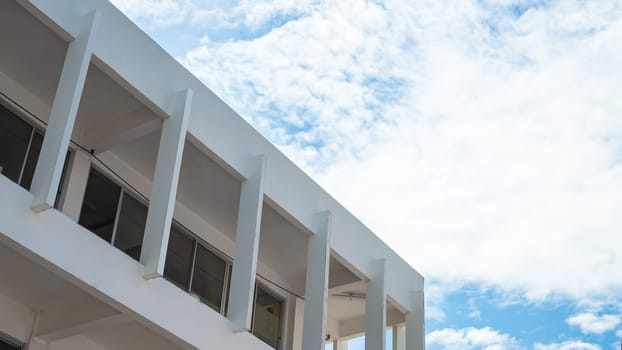 White building on a background of sky and white clouds