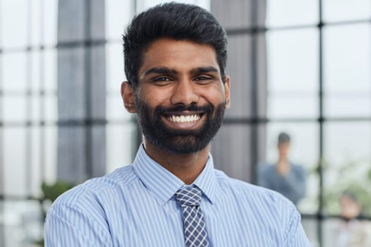 male investor beard looking at camera and smiling in modern office