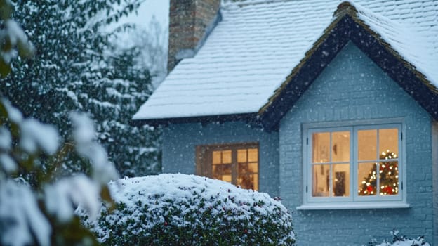 Christmas in the countryside, cottage decorated for holidays on a snowy winter evening with snow and holiday lights, English country styling inspiration