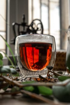 A cozy glass of steaming tea, reflecting warm colors harmoniously amidst beautifully arranged natural decor