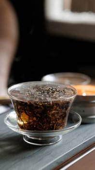 Aesthetic view of colorful herbal tea in an elegant glass infuser, showcasing its rich colors and textures