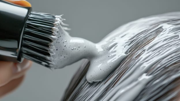 A Hairdresser applying hair product, showcasing glossy and healthy results on hair