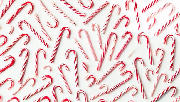 Two images of thin red and white striped candy canes randomly scattered on a flat white background. The flat lay arrangement creates a playful and casual pattern, with ample negative space around the candy canes.