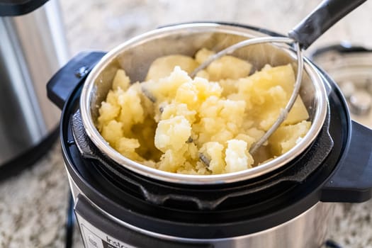 Discover the mouthwatering journey of salmon as it's cooked to perfection in an oven, nestled in a foil tray, adorned with rich butter and tantalizing spices. In a sleek modern kitchen, preparing velvety mashed potatoes using a pressure cooker for a quick and delicious meal.