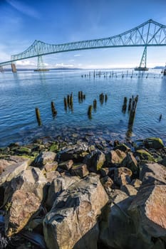 Large boulders lead into the image of the landmark bridge in Astoria, Oregon.