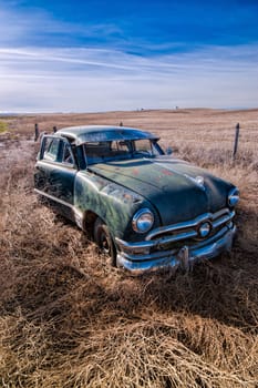 An old abandoned antique car sitting in a field in eastern Washington.