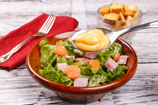 Close up of a delicious salad with honey mustard dressing.