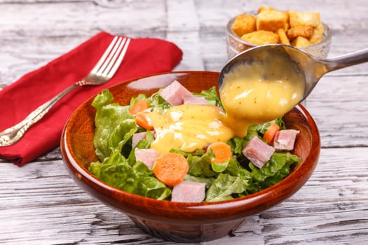 Close up of a delicious salad with honey mustard dressing.