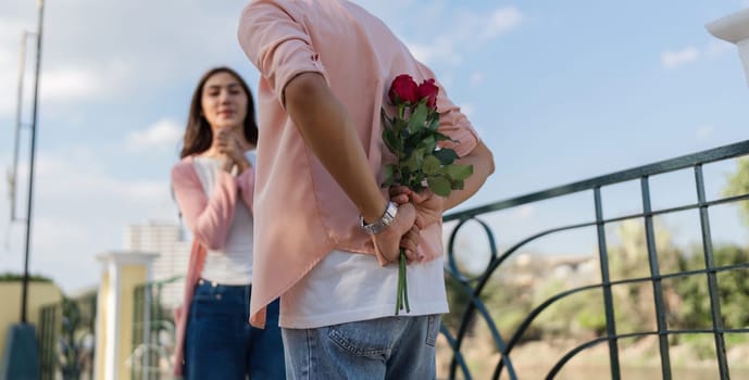 A couple shares a heartfelt moment as one surprises the other with roses capturing the essence of love and romance.