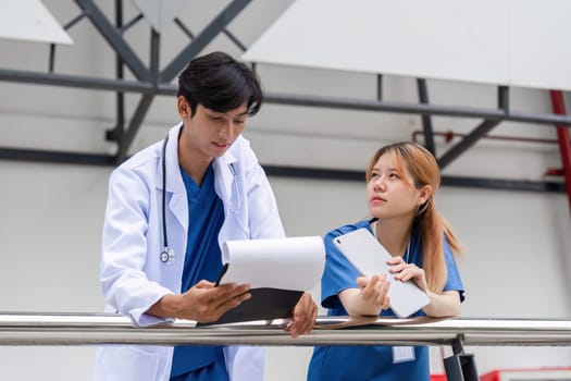 A healthcare team collaborates in a hospital discussing patient care strategies to enhance treatments and outcomes.
