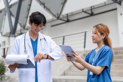 Two healthcare professionals collaborate on patient care showcasing teamwork and communication in a hospital environment.