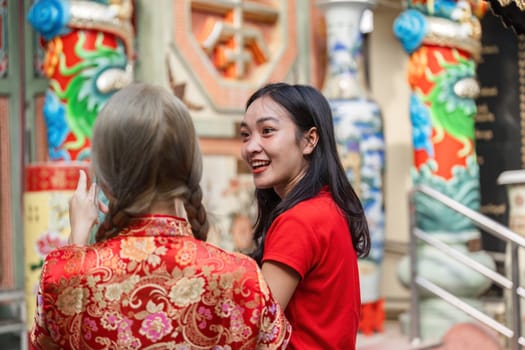 Witness the vibrant joy of worship and celebration at a shrine during Chinese New Year highlighting rich cultural traditions.