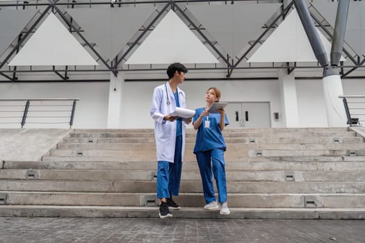 Two healthcare professionals discuss patient care strategies in a contemporary medical environment emphasizing collaboration and teamwork.
