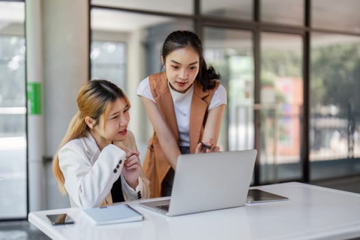 Two business professionals engaged in a collaborative discussion in a modern office environment, focusing on partnership and innovation.