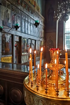 Veliky Novgorod, Russia - July 31, 2024. Candles glow in the Sofia Cathedral. The atmosphere is serene and spiritual.