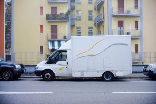 Cremona, Itally - October 6th 2024 White ford transit box truck parked on a residential street, possibly employed for delivery services or small business activities
