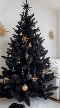 A stylish black Christmas tree adorned with gold decorations.