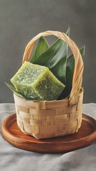 A small woven basket containing green dessert and leaves.