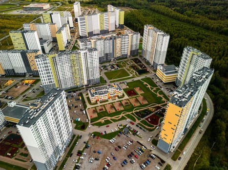 An aerial photo of a modern residential neighborhood with greenery and contemporary architectural designs
