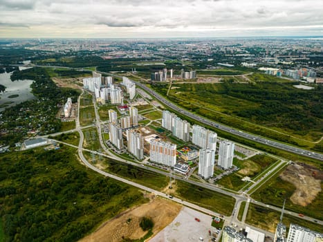 An aerial view showcasing the harmony between modern urban architecture and vibrant natural greenery