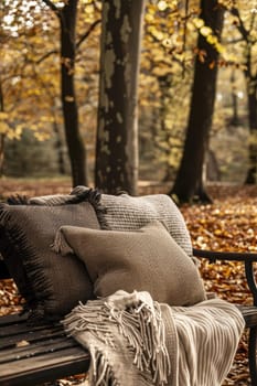 Autumnal park scene featuring an ornate bench with mocha mousse cushions and cozy blankets, surrounded by vibrant fall foliage. ideal for seasonal decor, relaxation themes, or autumn travel promotions.