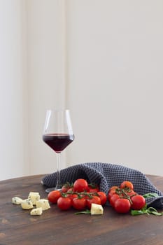 A beautiful mix of ripe tomatoes, creamy cheese, and a glass of red wine creates a lovely ambiance for any occasion